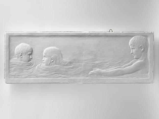 Schwarzes und weißes Foto von drei Kindern, die im Wasser schwimmen, mit einer Wand im Hintergrund.