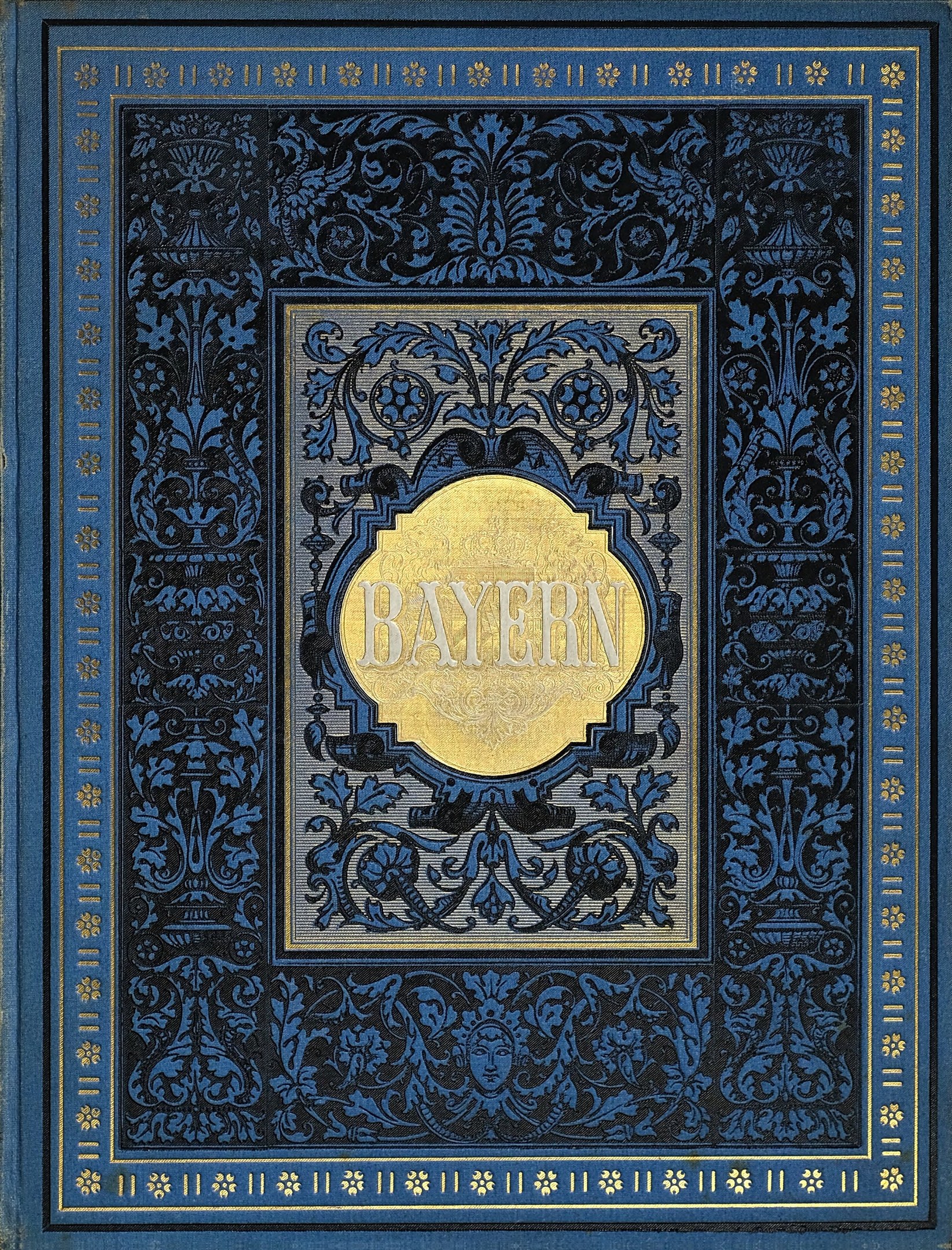 Ein blau-goldenes Buch mit dem Wort "Bayern" auf seinem kunstvoll gestalteten Umschlag.